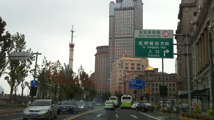 cars are traveling down a busy street in the city