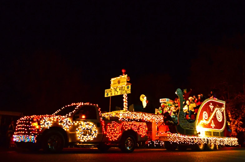 a truck parked in front of a building covered with christmas lights