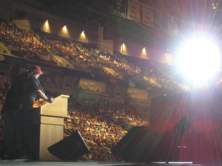 the person is speaking into the microphone on the stage