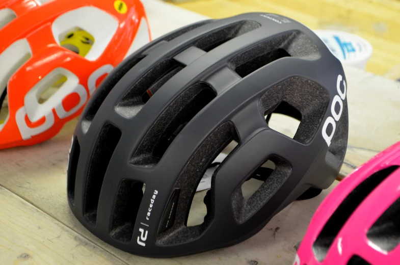 a close up of three different helmets with one helmet on