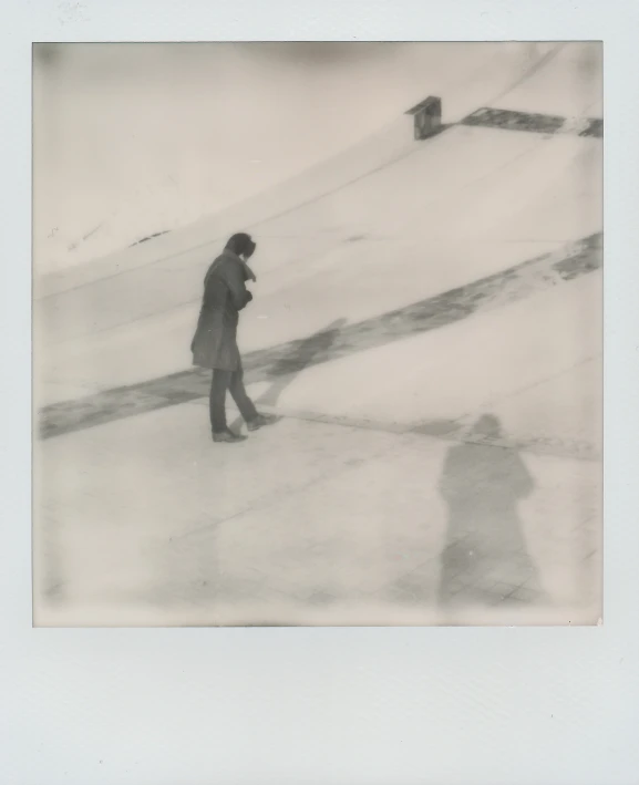 two people are walking in the snow by a path