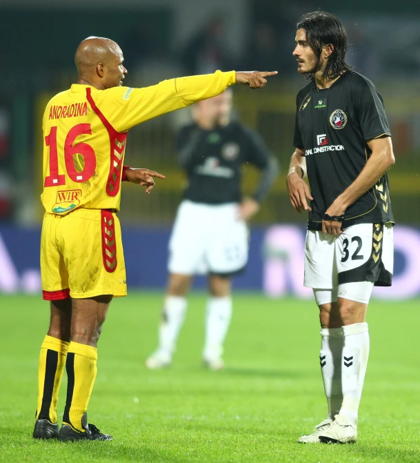 referee gives instructions to soccer players during a match