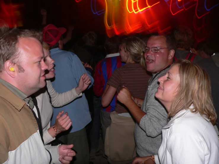 a group of people dancing at a club