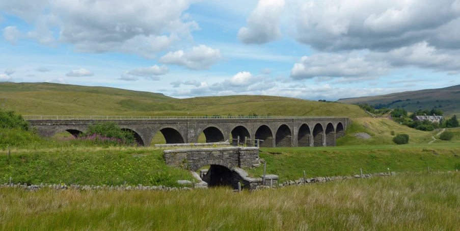 a stone bridge that has arches over it