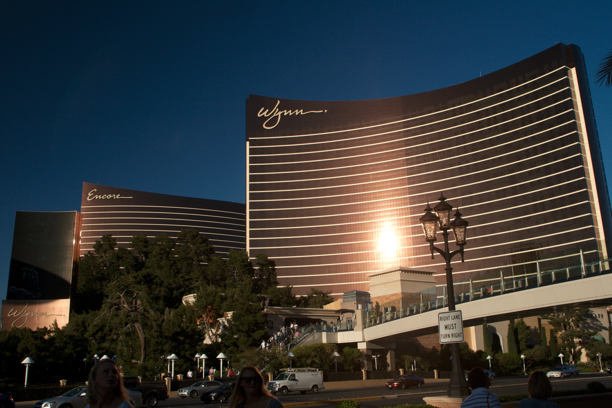 people walk in front of the wynn casino and casino in las vegas