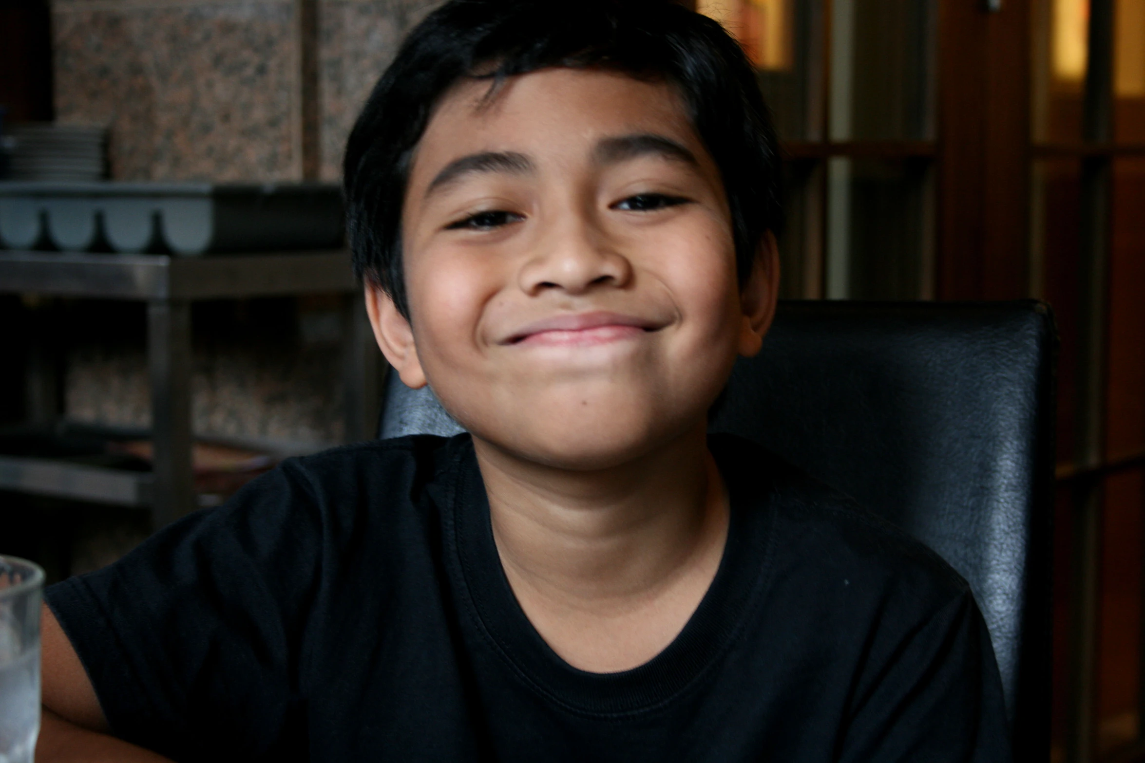 a child in a black shirt at a table