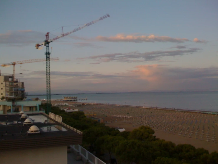 a view of an outdoor restaurant, beach, and crane