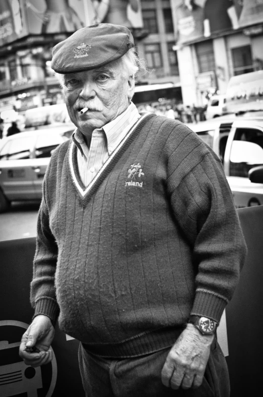 an old man smoking a cigarette on the street