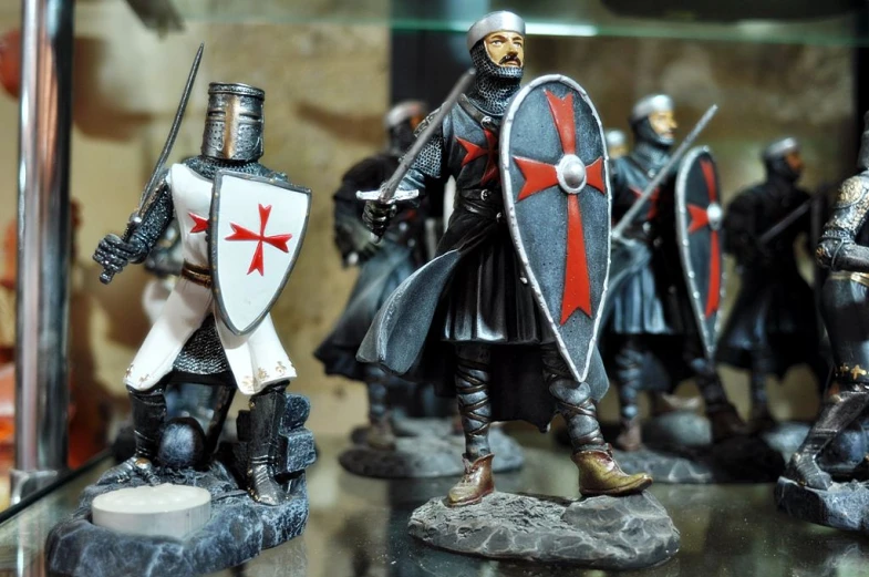 a group of knights with weapons and armor are on display