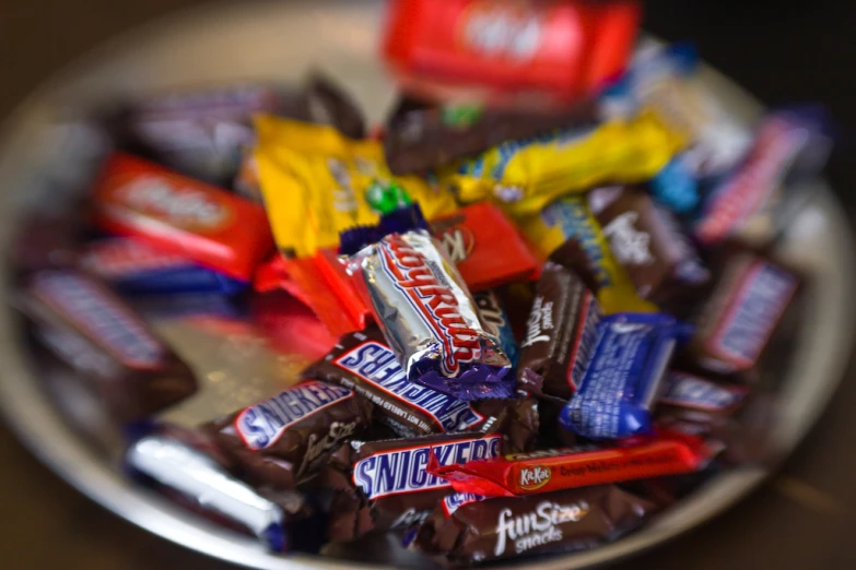 a white bowl filled with different types of candy