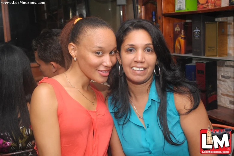 two women pose for a po at an event