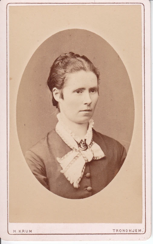 an old fashion po of a woman wearing a bow