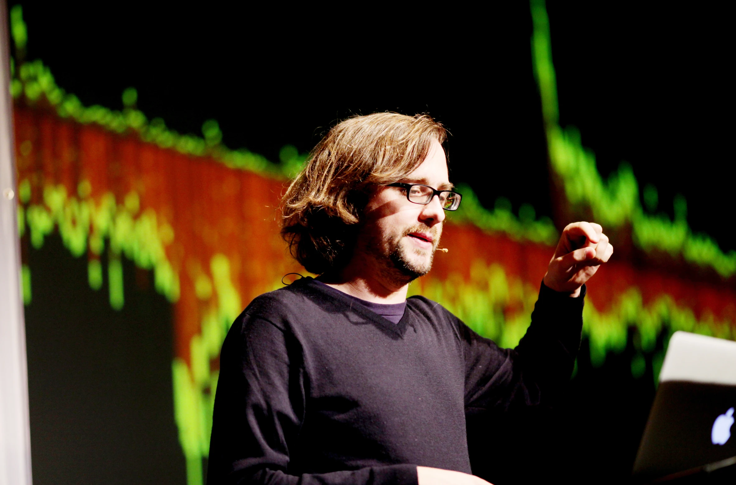 there is a man giving a lecture in front of a projector