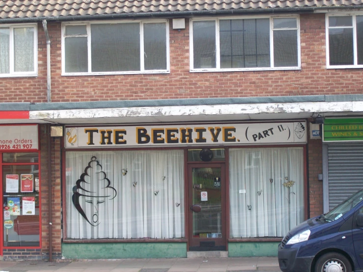 a brick store front with open doors and graffiti