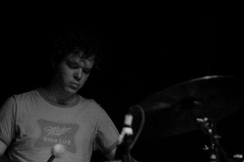 a man playing drums in the dark