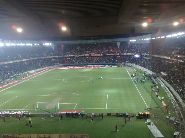 the players of a soccer game on a stadium field