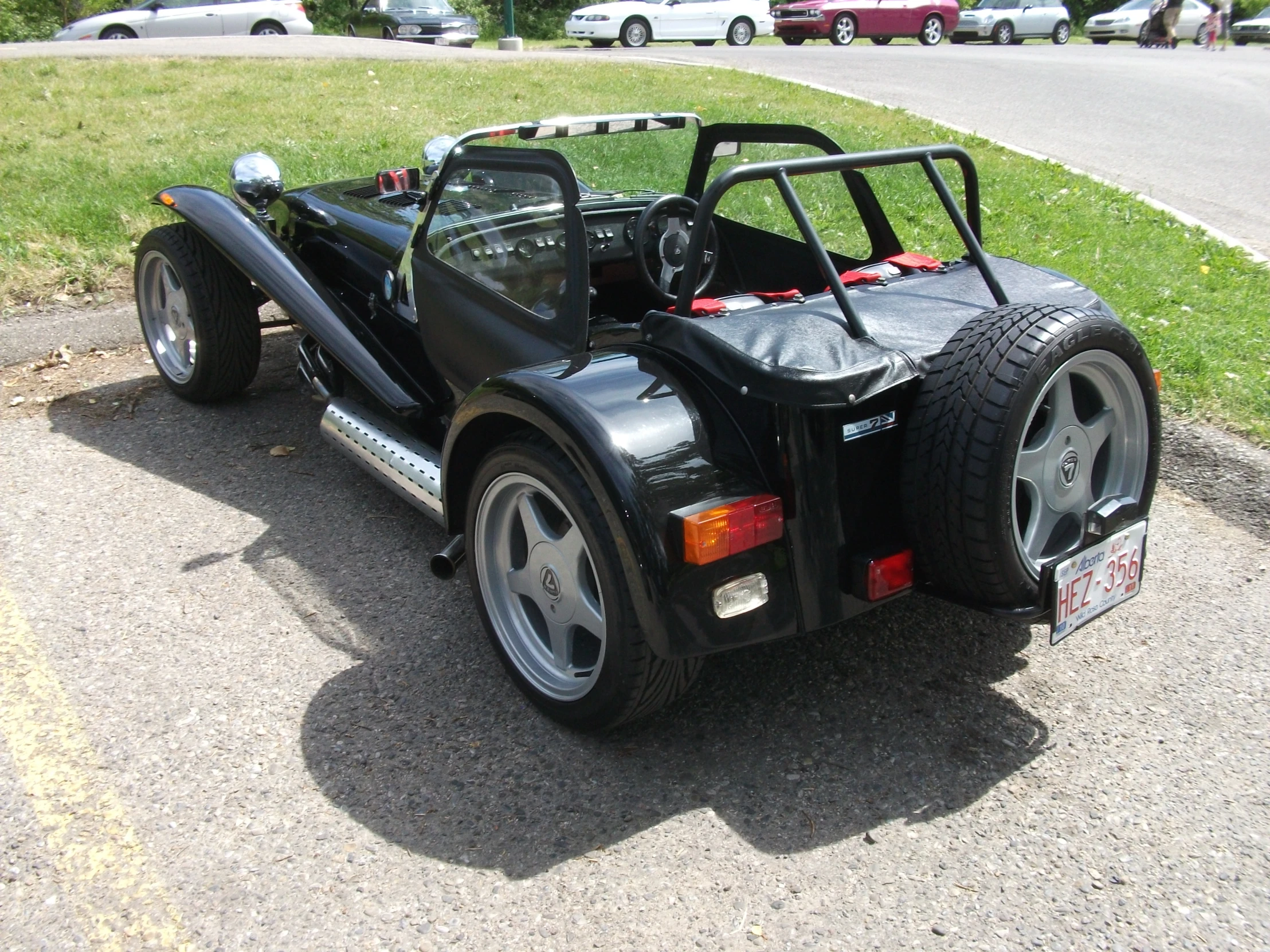 a car with the roof down parked on the street