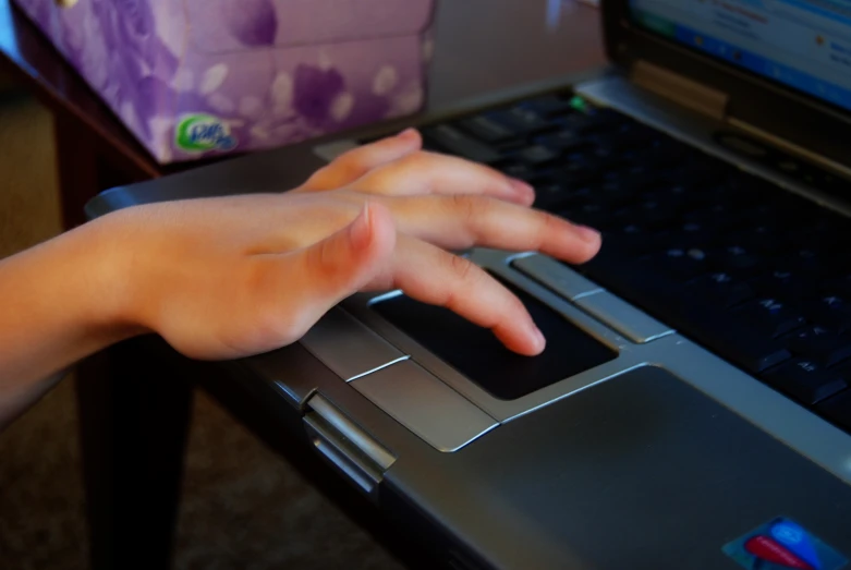 the hands are on the keys of a laptop