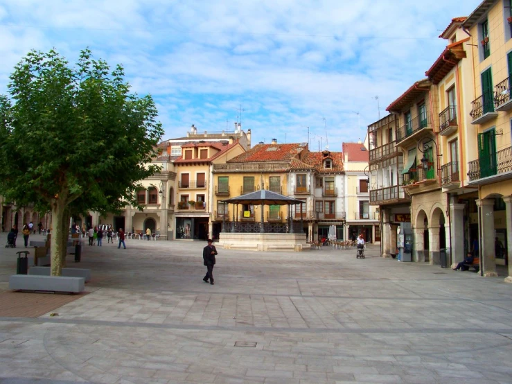 several people walking through an old town square