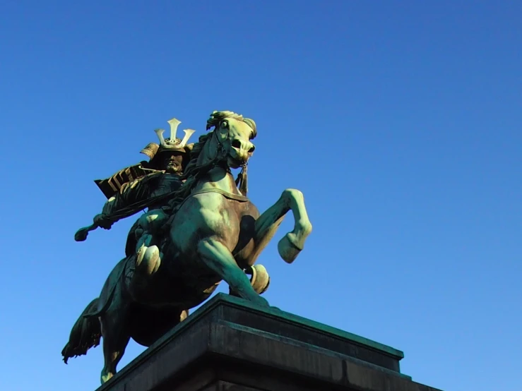 the statue is in the middle of a clear blue sky