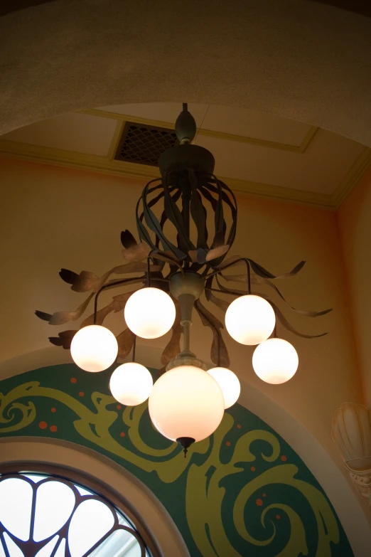 the ceiling light fixture has six globes and lights on it