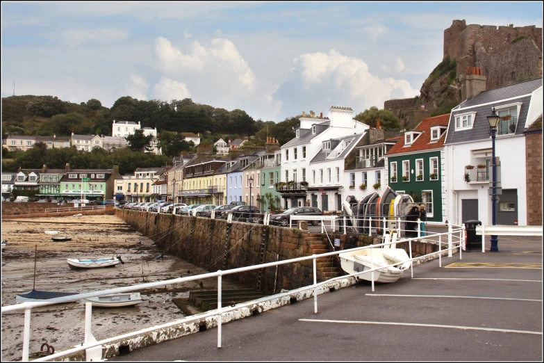 a group of buildings line the shore in the distance