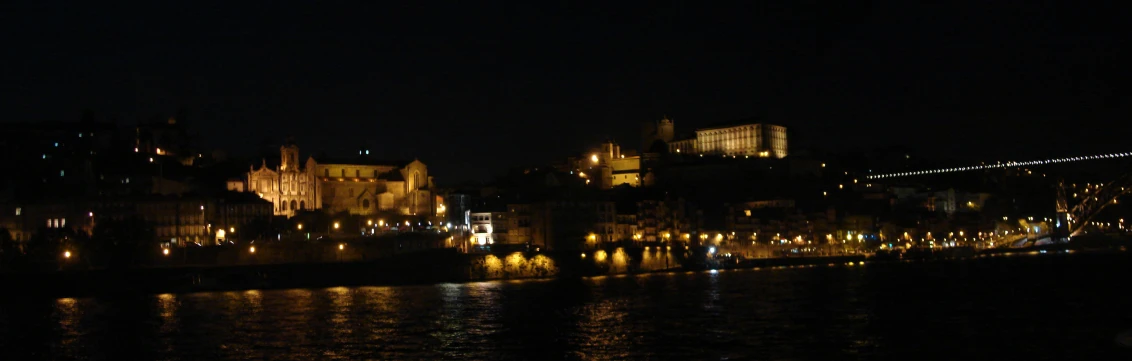 a city lit up with lights reflecting on water