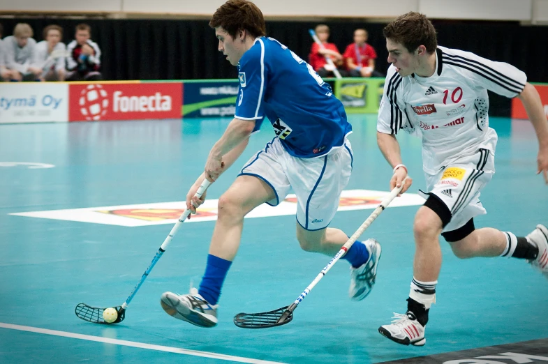 men in action on the court during a game of hockey
