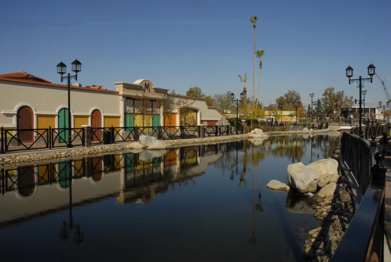 a reflection of colorful building and water in the water