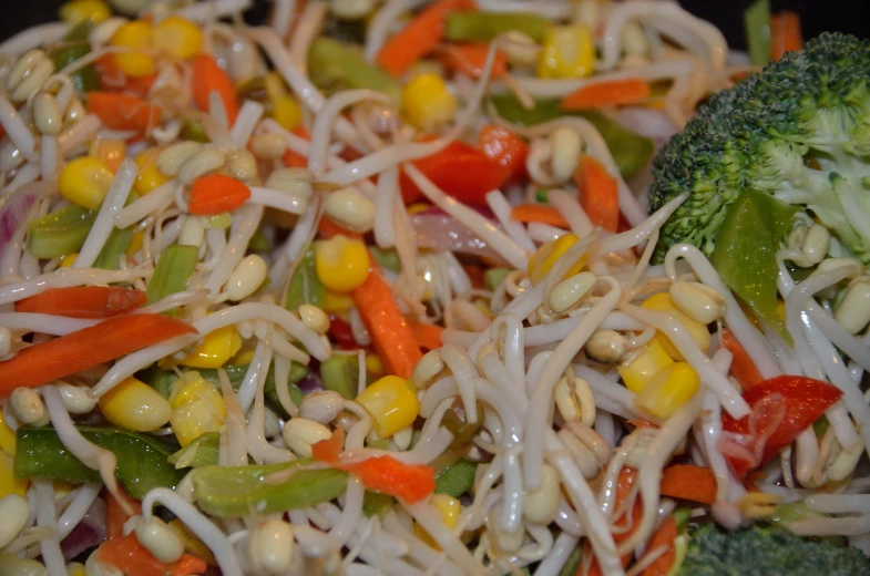 a plate filled with food that includes rice, veggies and other vegetables