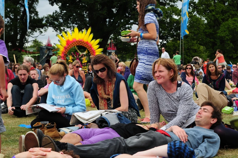 several people gathered at a public gathering to listen to the speaker