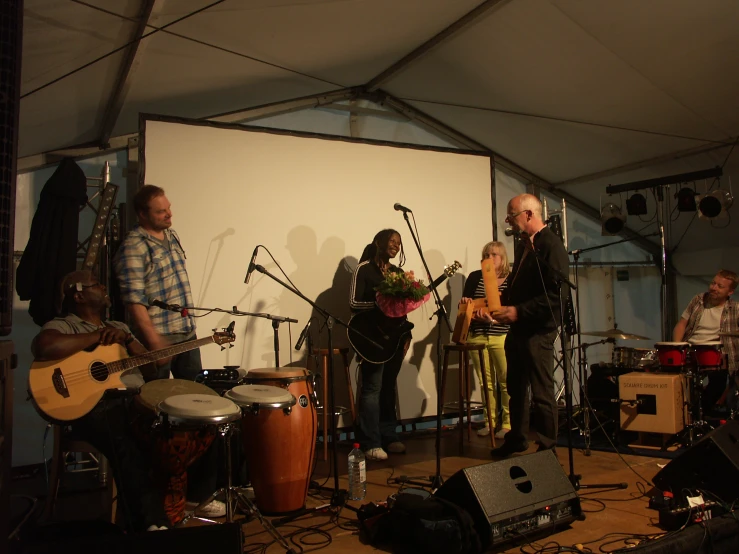 a group of people playing instruments on stage