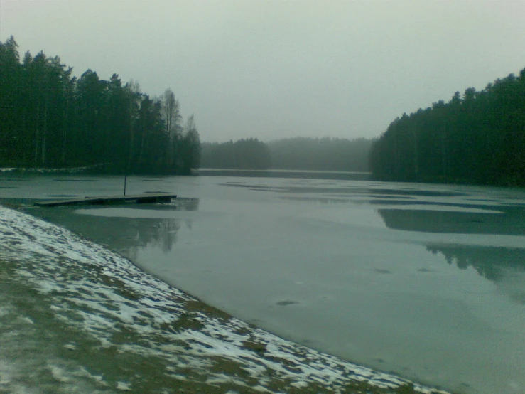 the snow has fallen down and the ice is still on the water