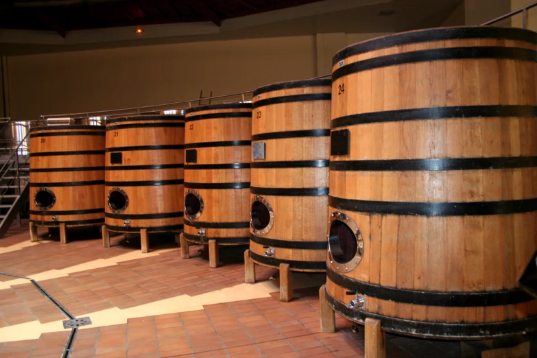 a row of wooden barrels that have black bands