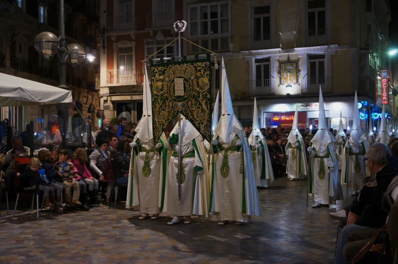 a group of people gathered around to observe a procession