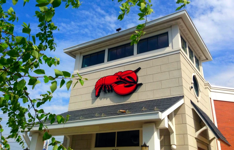 a red crab sits on the top of the restaurant