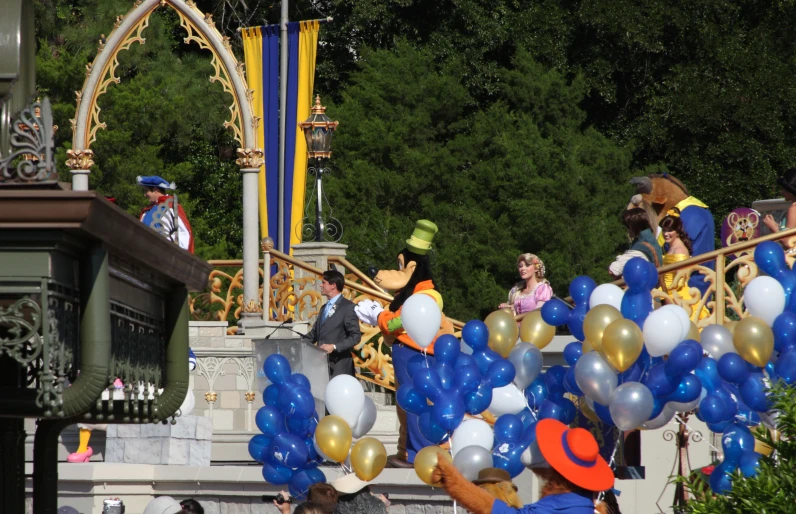 people are walking down steps with balloons on them