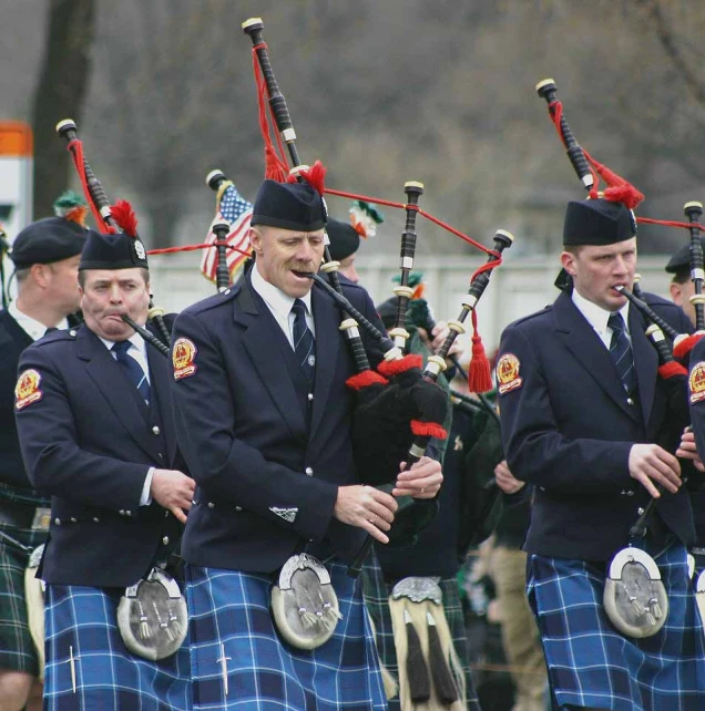 the man is wearing a uniform with tartans on it