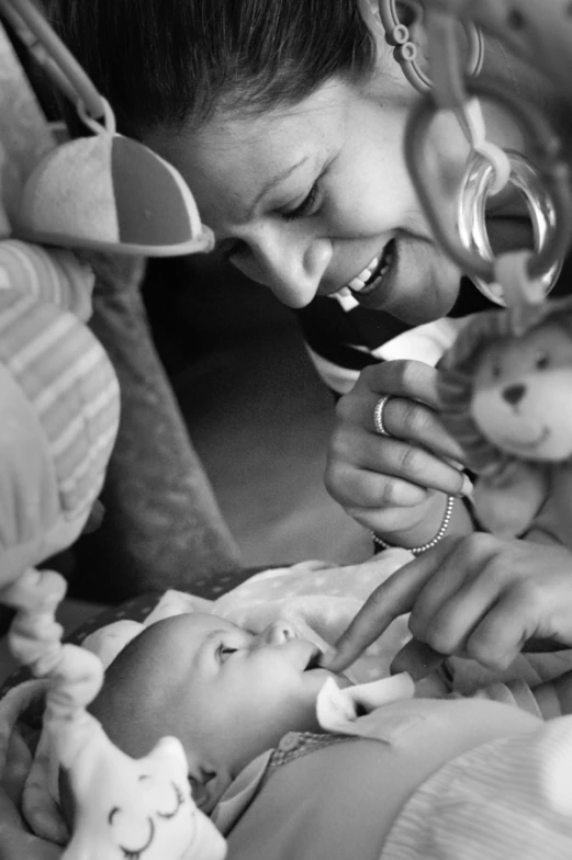 the woman is feeding her baby some treats