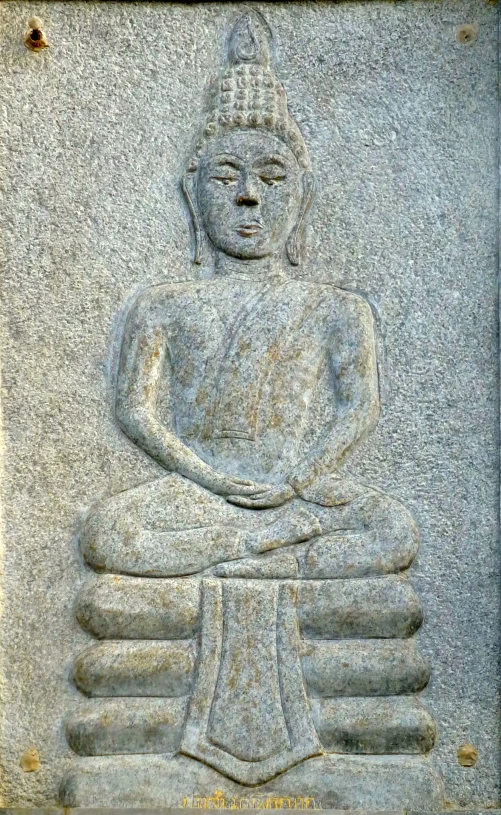 an intricate carved buddha statue sitting in the corner