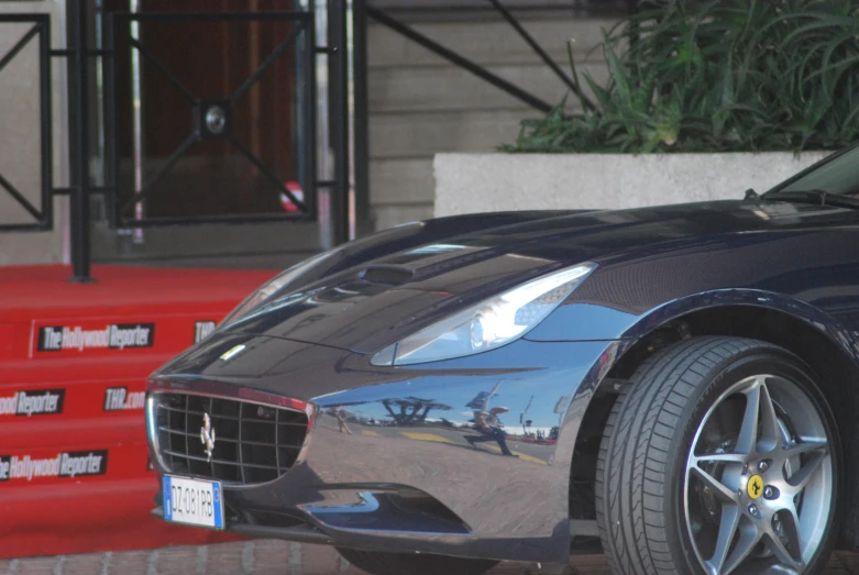 a car parked outside of a building near red stairs