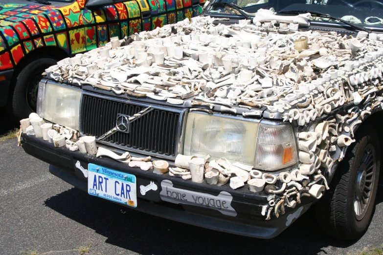 a lot of stuff sitting on top of the grill of a car