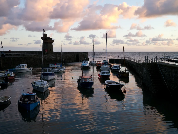 a group of boats are parked next to the pier