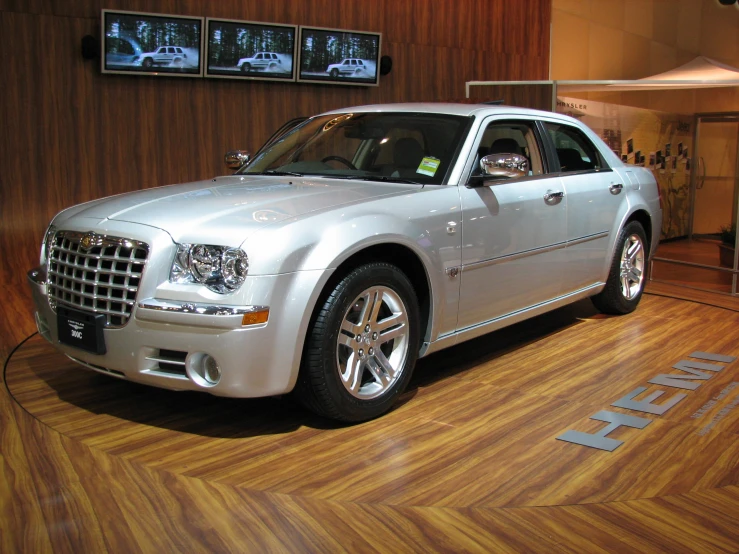 a silver car parked on display inside of a building