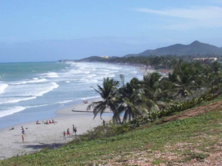 a beach scene with the ocean in the distance