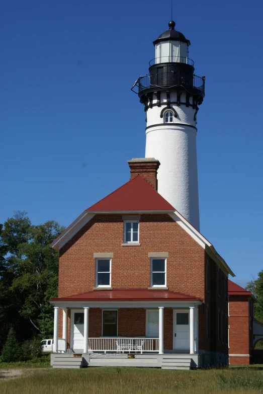 this is a white and black lighthouse on top of a building