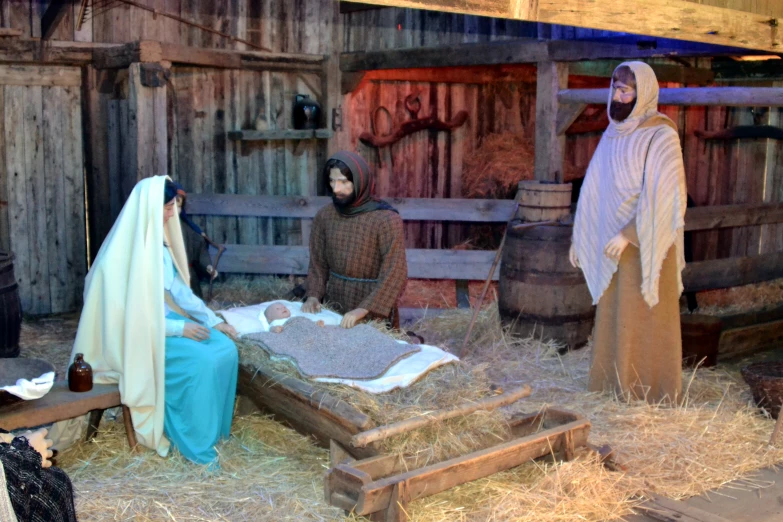 a nativity scene with a person laying on the ground