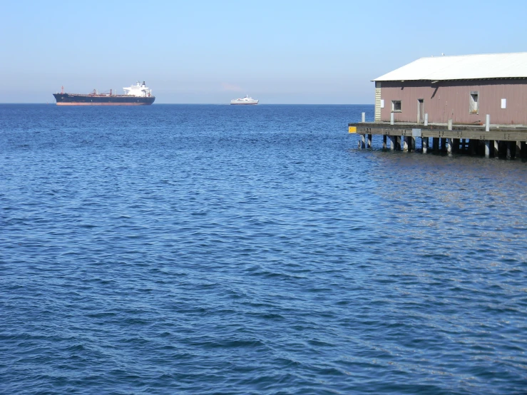 a large boat and a tanker ship on the ocean