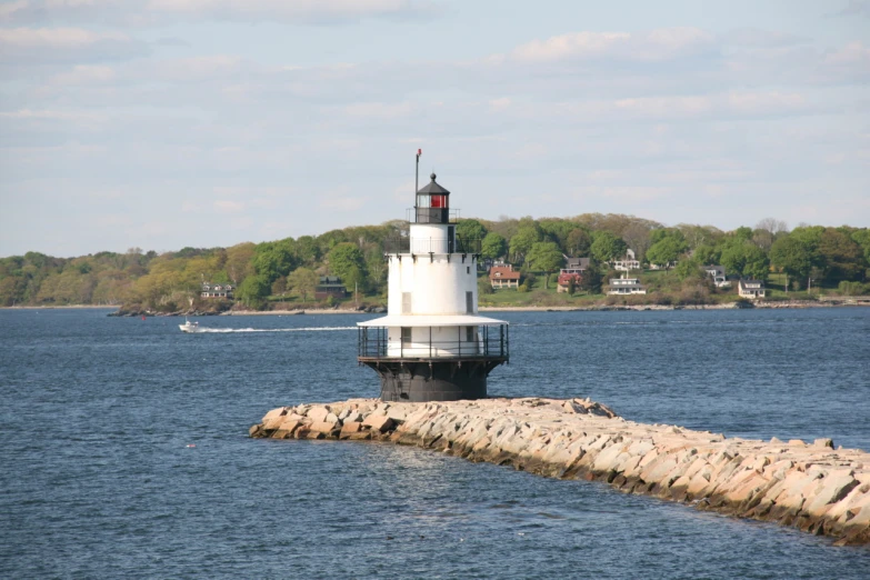 a light house on the edge of a large body of water