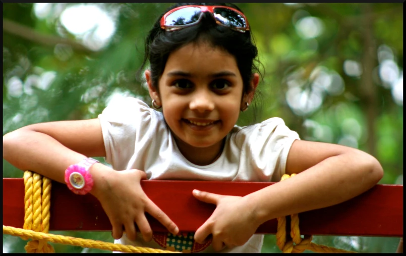 a little girl standing at a playground looking like she is ready to jump